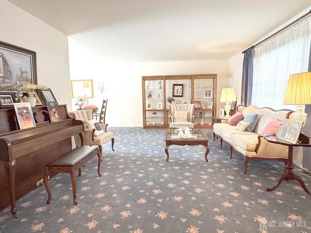 a living room with furniture and a floor to ceiling window