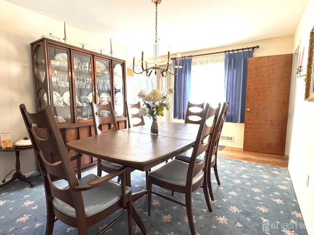 a view of a dining room with furniture and window