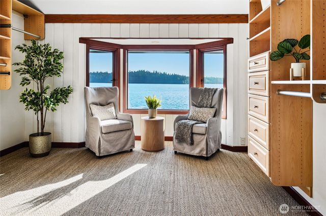 a living room with furniture and potted plants