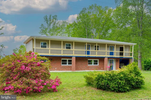 a view of a house with a yard and garden