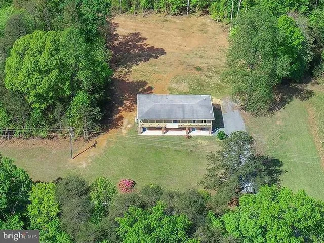 a view of a green field with lots of bushes
