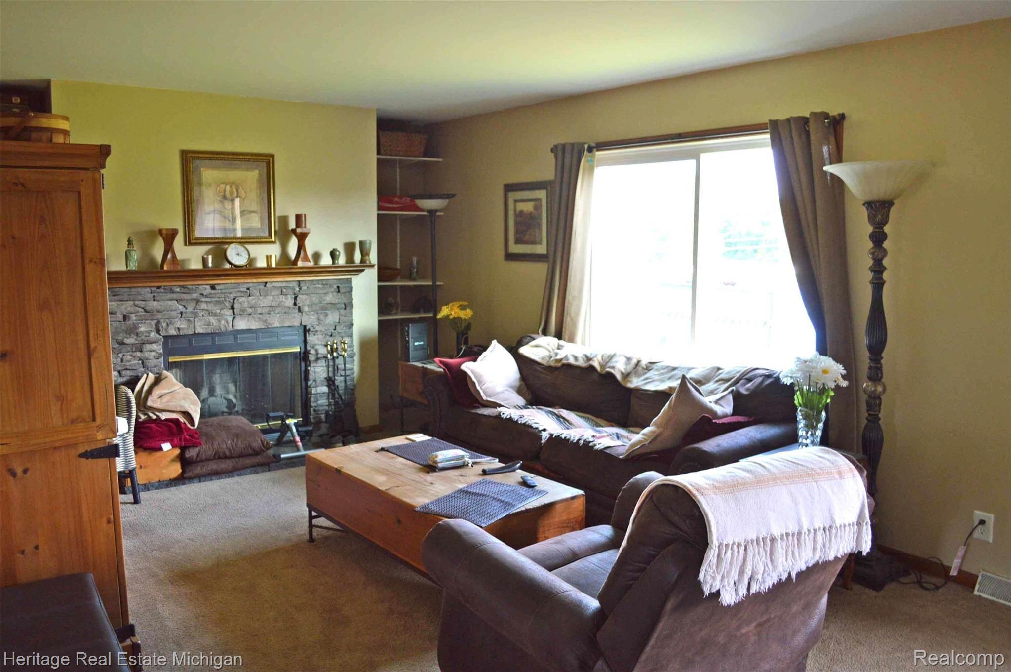 285 North Hughes Road Howell, MI 48843 - Photo 2 of 13 Spacious living room with fireplace