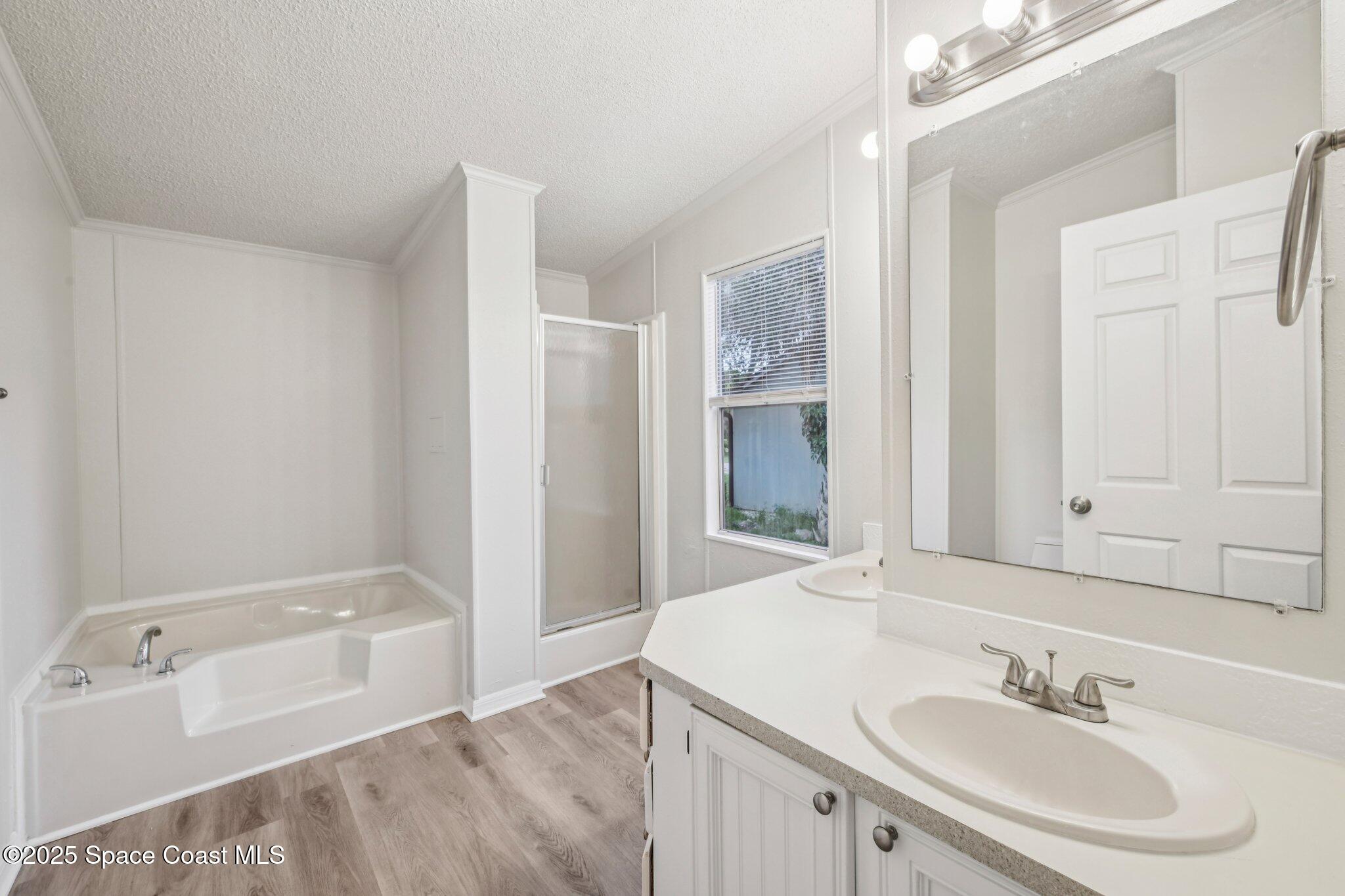 7070 Bismark Road Cocoa, FL 32927 - Photo 15 of 33 a bathroom with a bathtub sink and mirror
