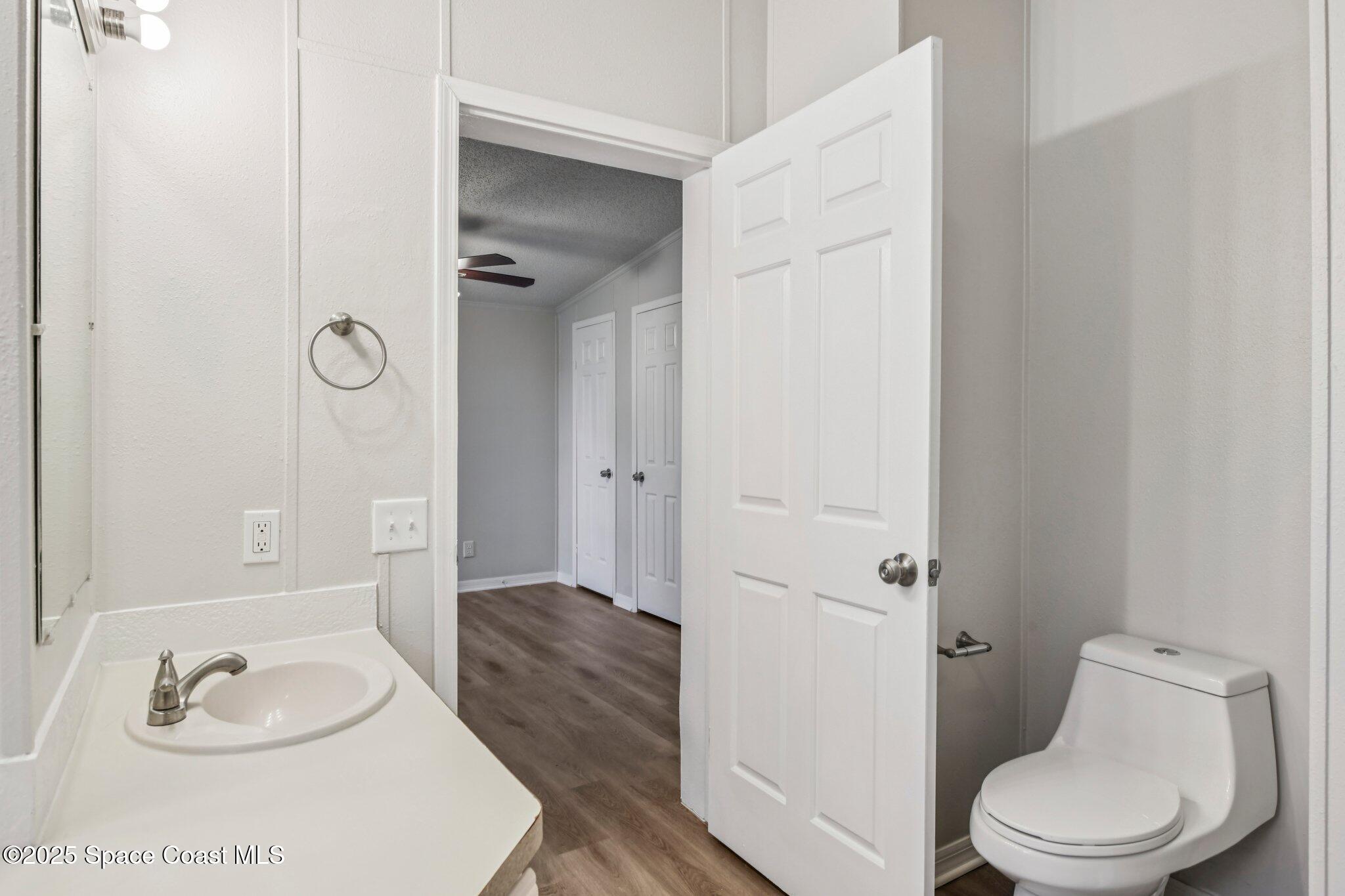 7070 Bismark Road Cocoa, FL 32927 - Photo 17 of 33 a bathroom with a granite countertop sink toilet and shower