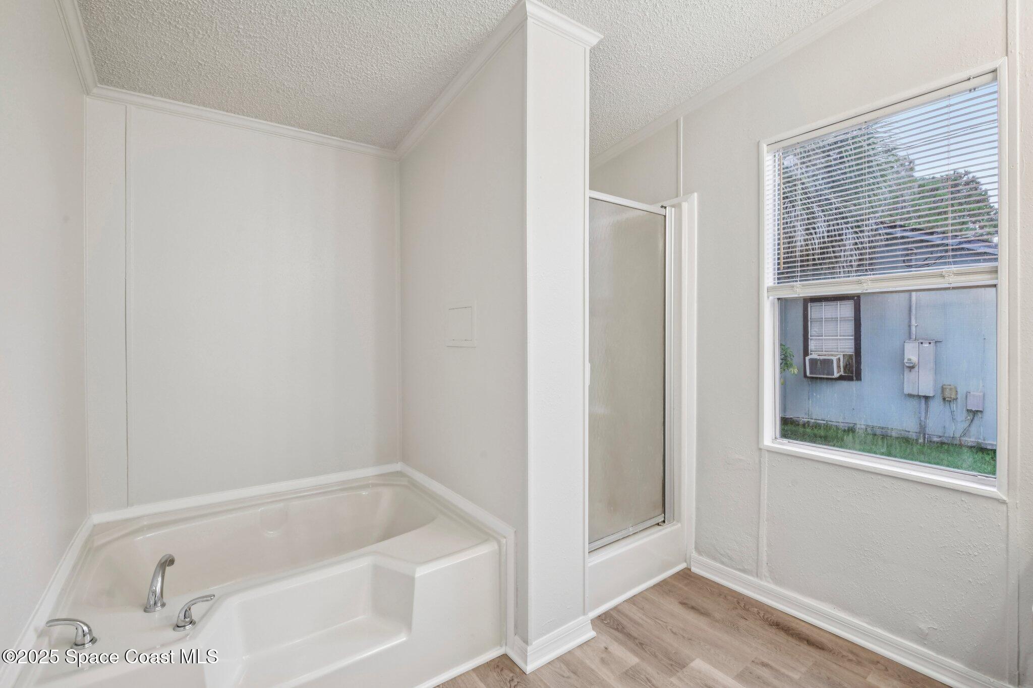 7070 Bismark Road Cocoa, FL 32927 - Photo 17 of 38 a bathroom with a bathtub and a shower