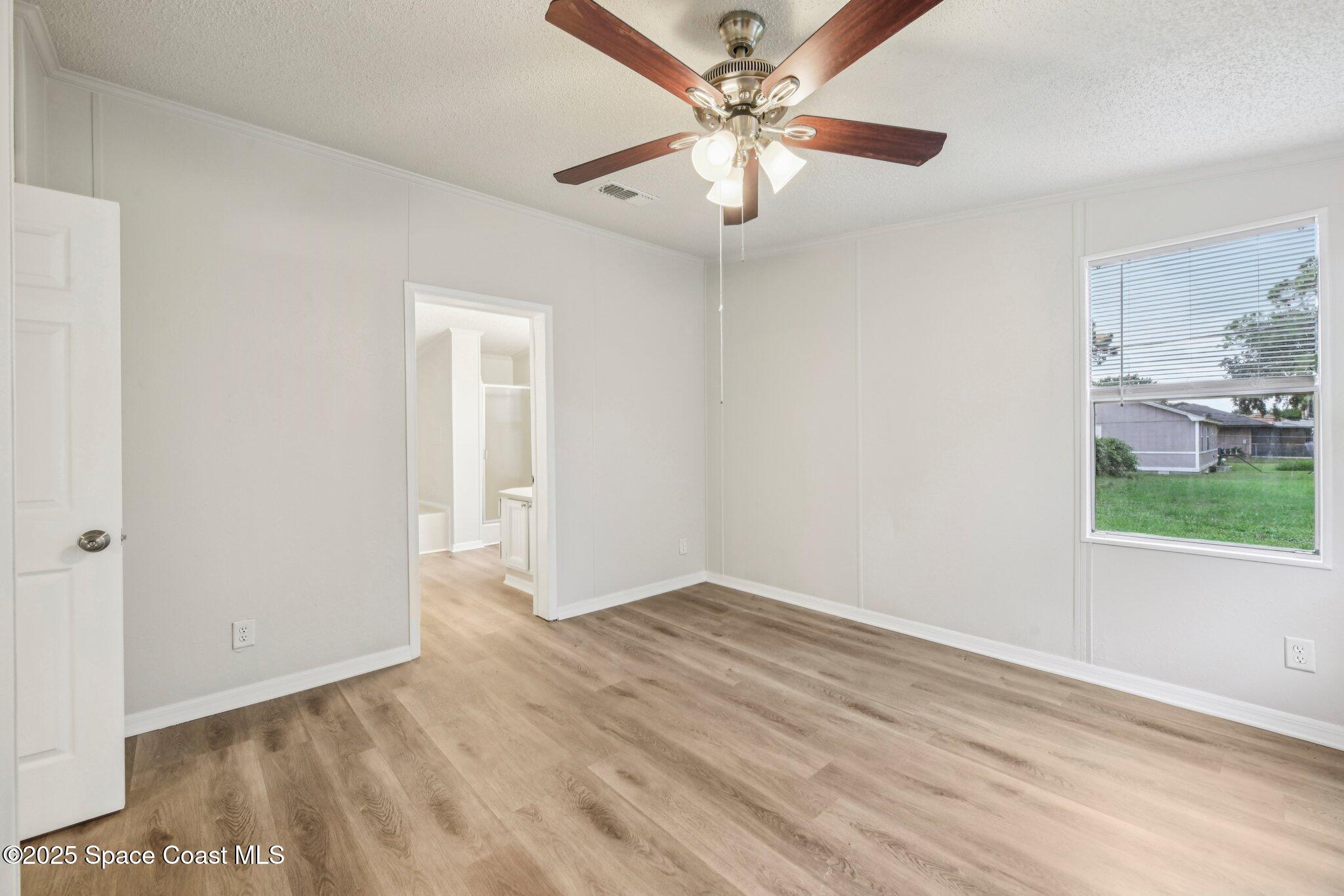 7070 Bismark Road Cocoa, FL 32927 - Photo 30 of 38 wooden floor in an empty room with a window