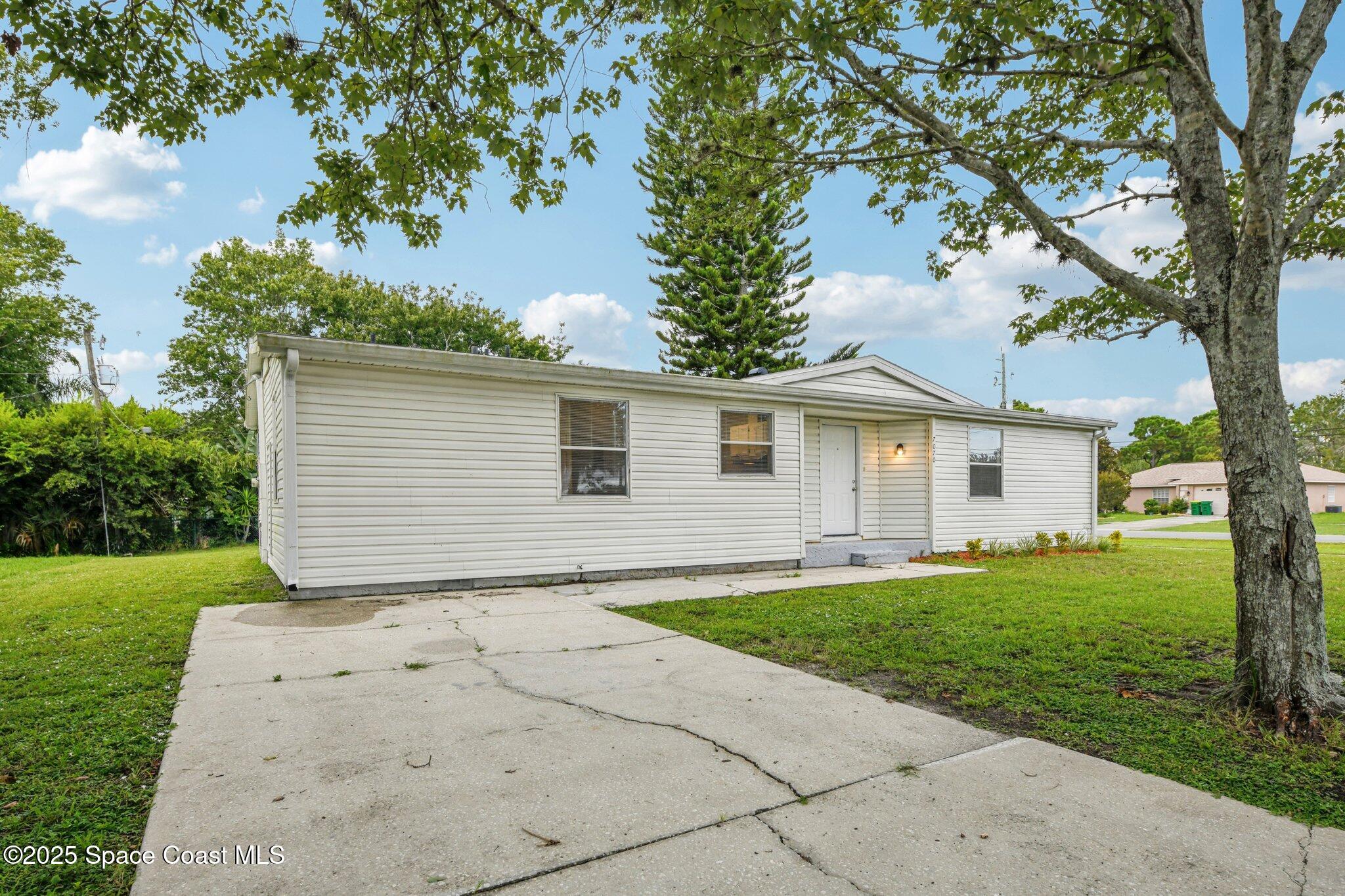 7070 Bismark Road Cocoa, FL 32927 - Photo 3 of 38 a view of a house with a yard