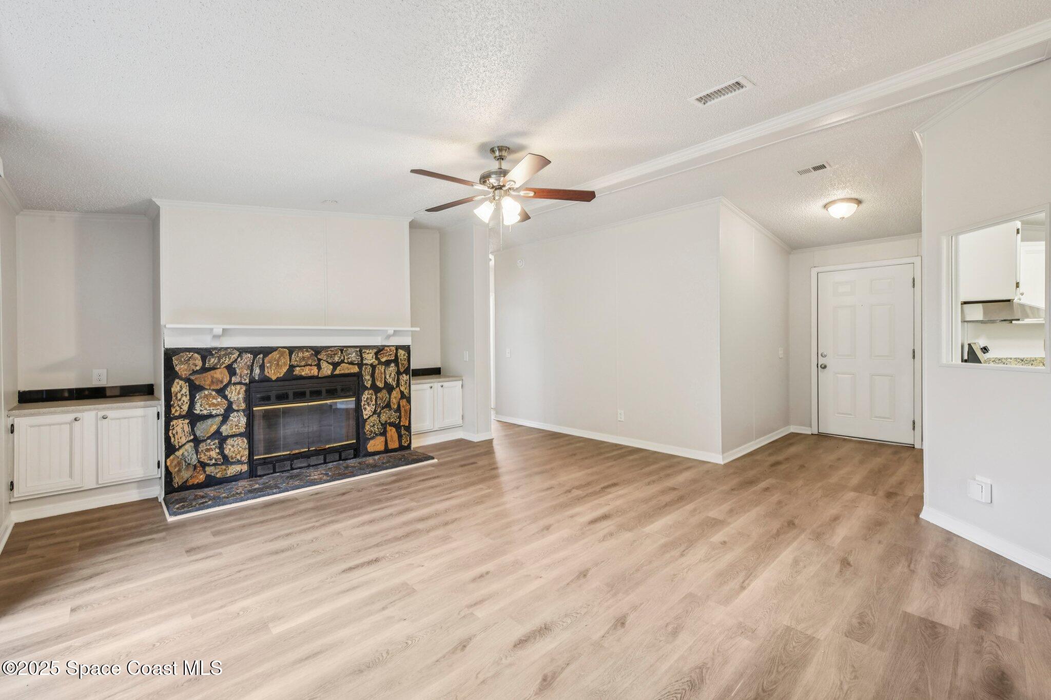 7070 Bismark Road Cocoa, FL 32927 - Photo 5 of 38 a view of an empty room with a fireplace and a window