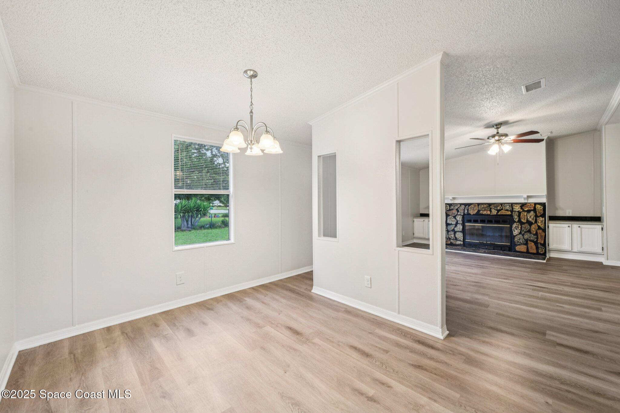 7070 Bismark Road Cocoa, FL 32927 - Photo 8 of 33 a view of a kitchen with a sink cabinet fire place and wooden floor