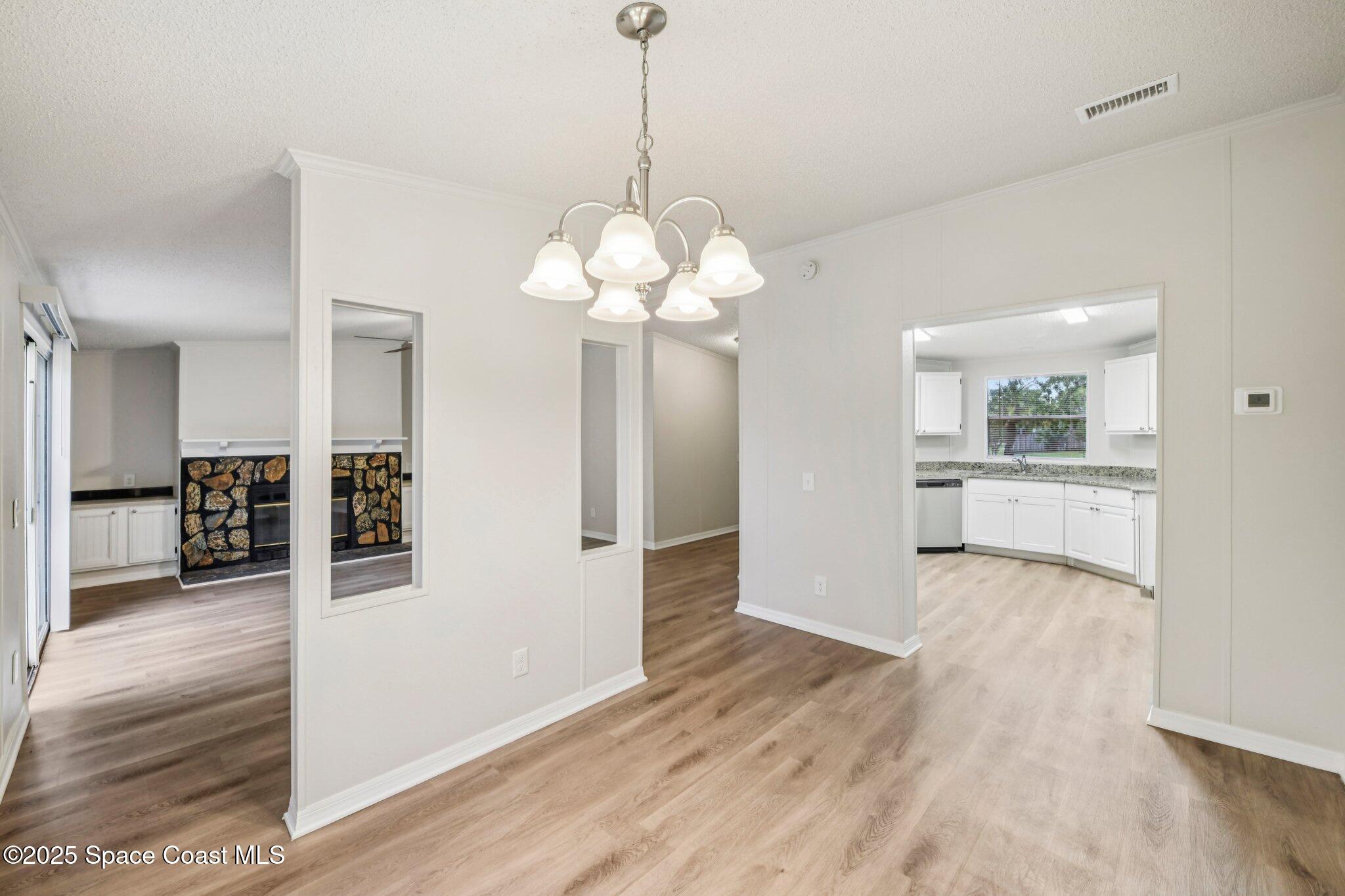 7070 Bismark Road Cocoa, FL 32927 - Photo 9 of 33 a view of a kitchen with wooden floor and a large window