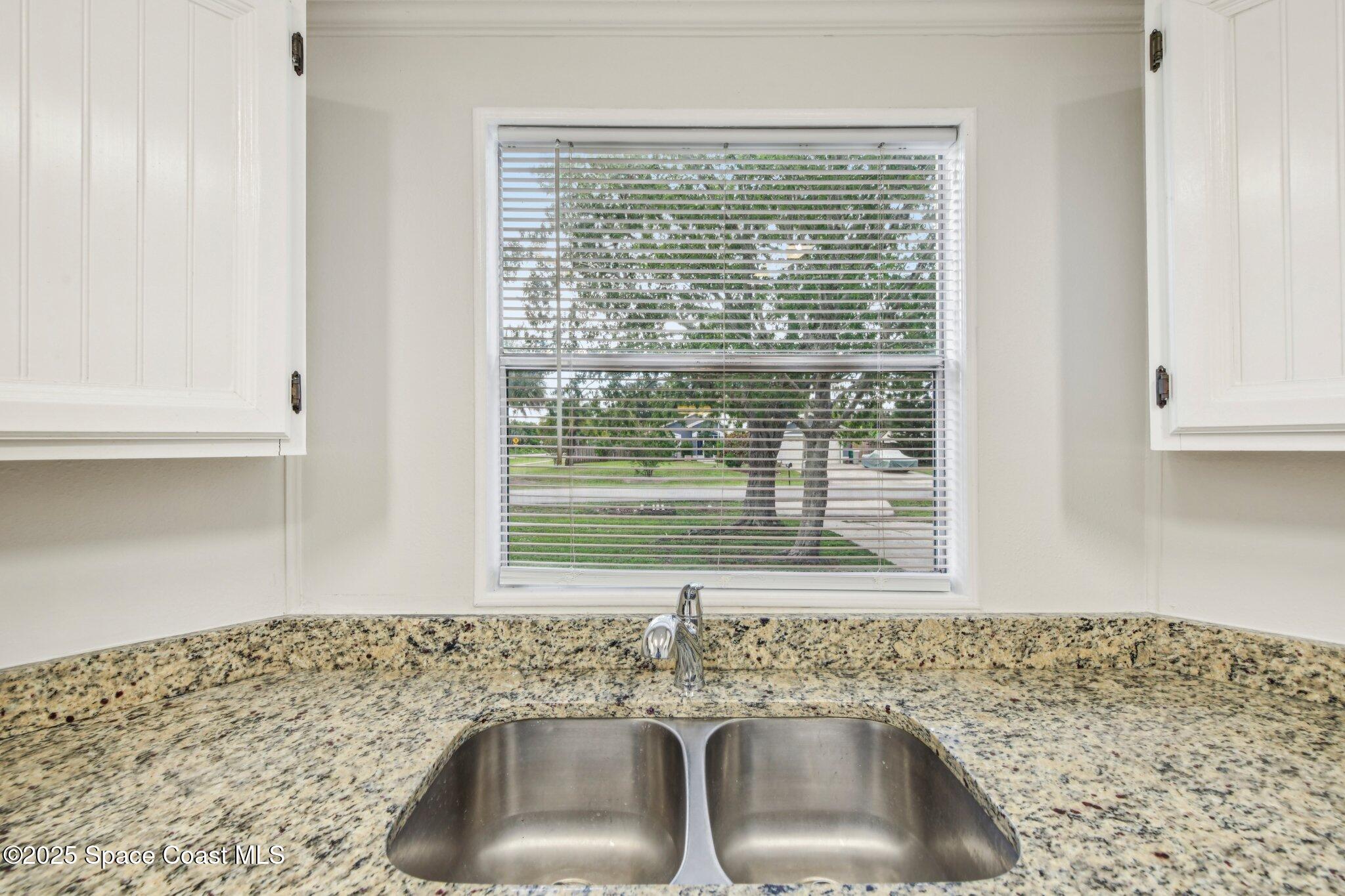 7070 Bismark Road Cocoa, FL 32927 - Photo 10 of 33 a kitchen with a sink cabinets and a window