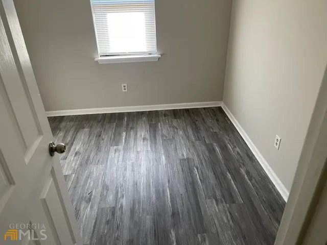 a view of a room with wooden floor and window