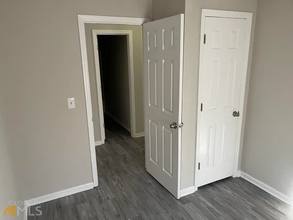a view of a hallway with wooden floor