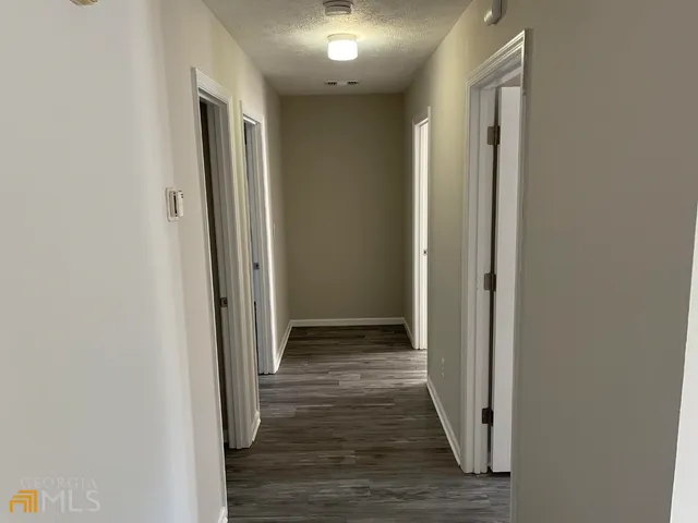 a view of hallway with wooden floor