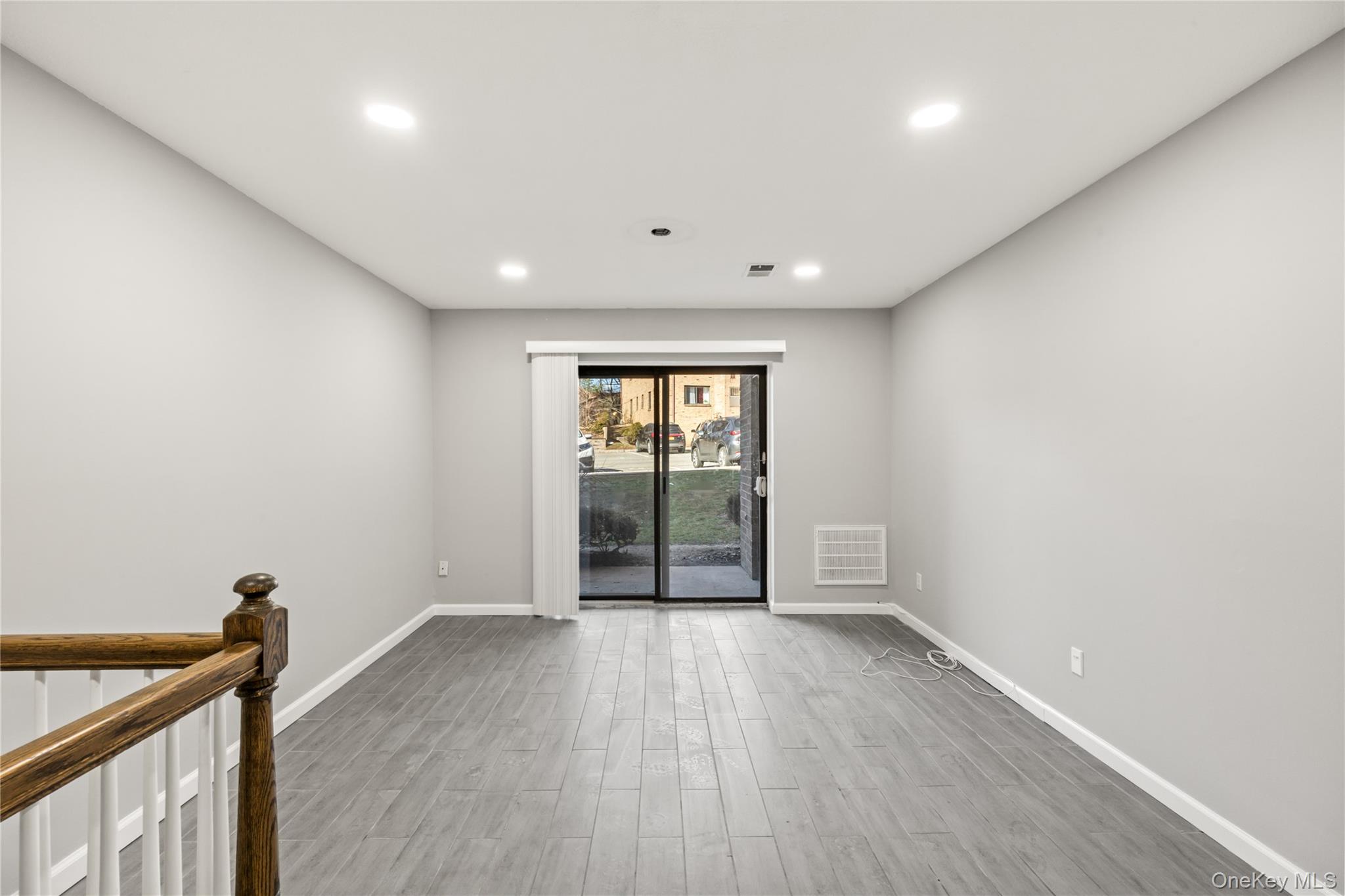 402 Kennedy Drive Spring Valley, NY 10977 - Photo 11 of 26 wooden floor in an empty room with a window