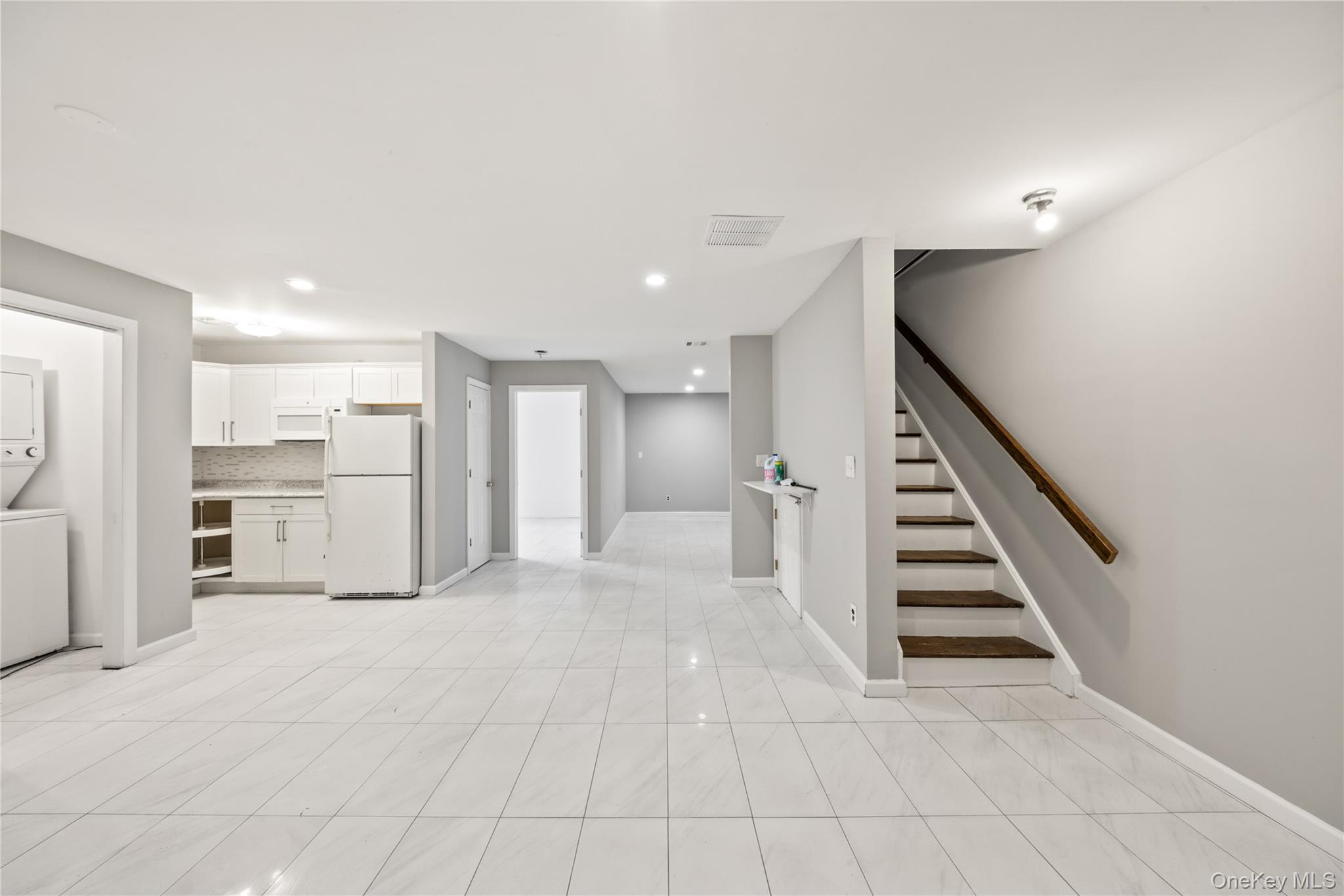 402 Kennedy Drive Spring Valley, NY 10977 - Photo 17 of 26 a view of a kitchen with wooden floor and staircase