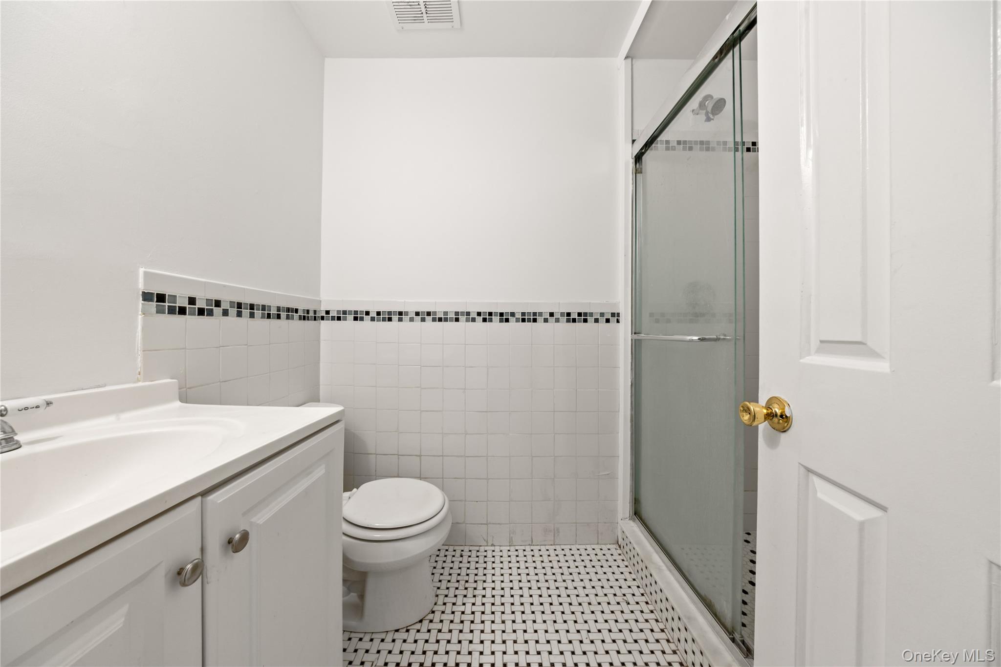 402 Kennedy Drive Spring Valley, NY 10977 - Photo 20 of 26 a bathroom with a toilet a sink and a shower