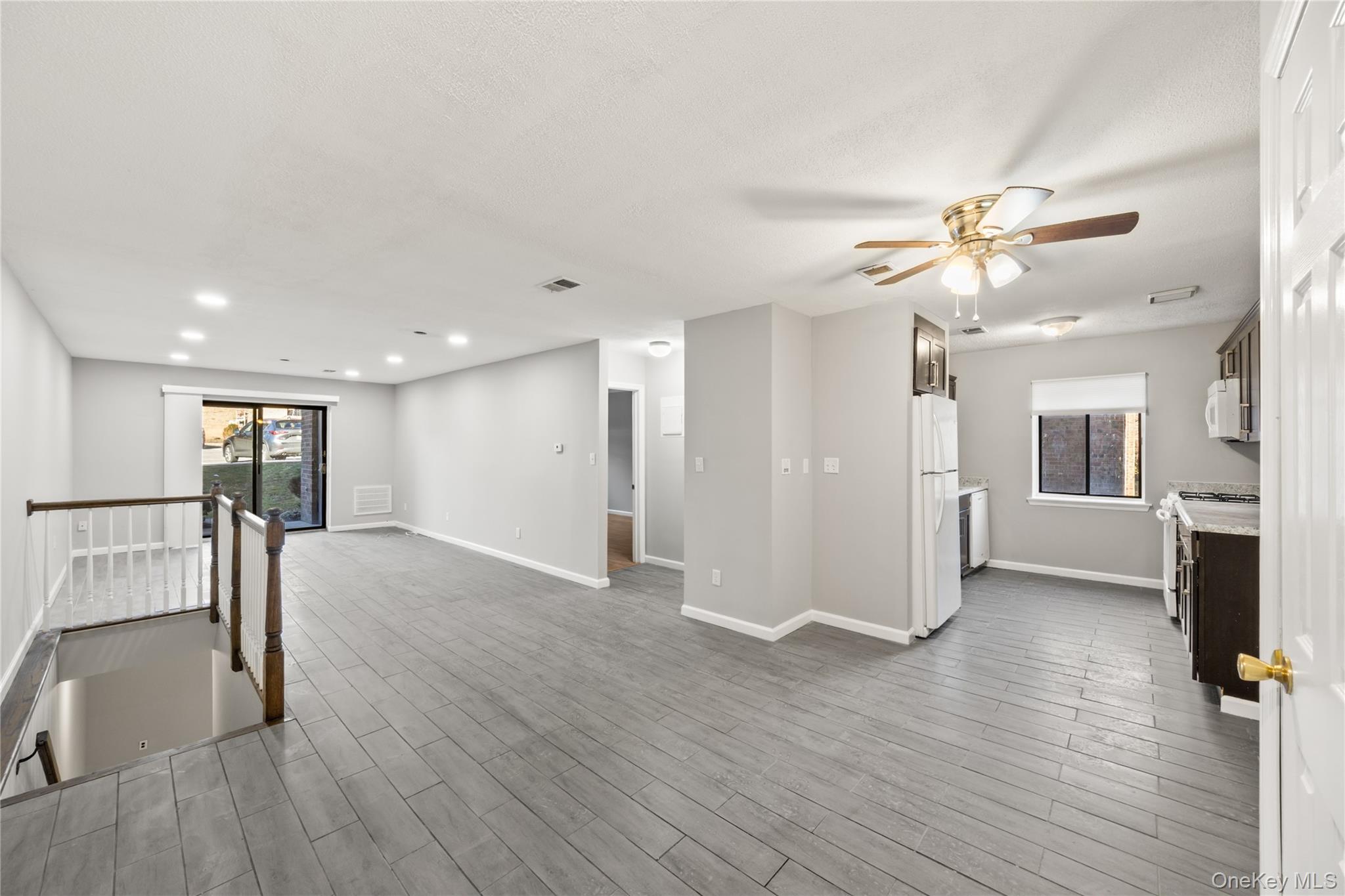 402 Kennedy Drive Spring Valley, NY 10977 - Photo 3 of 26 a view of livingroom with hardwood floor and a ceiling fan