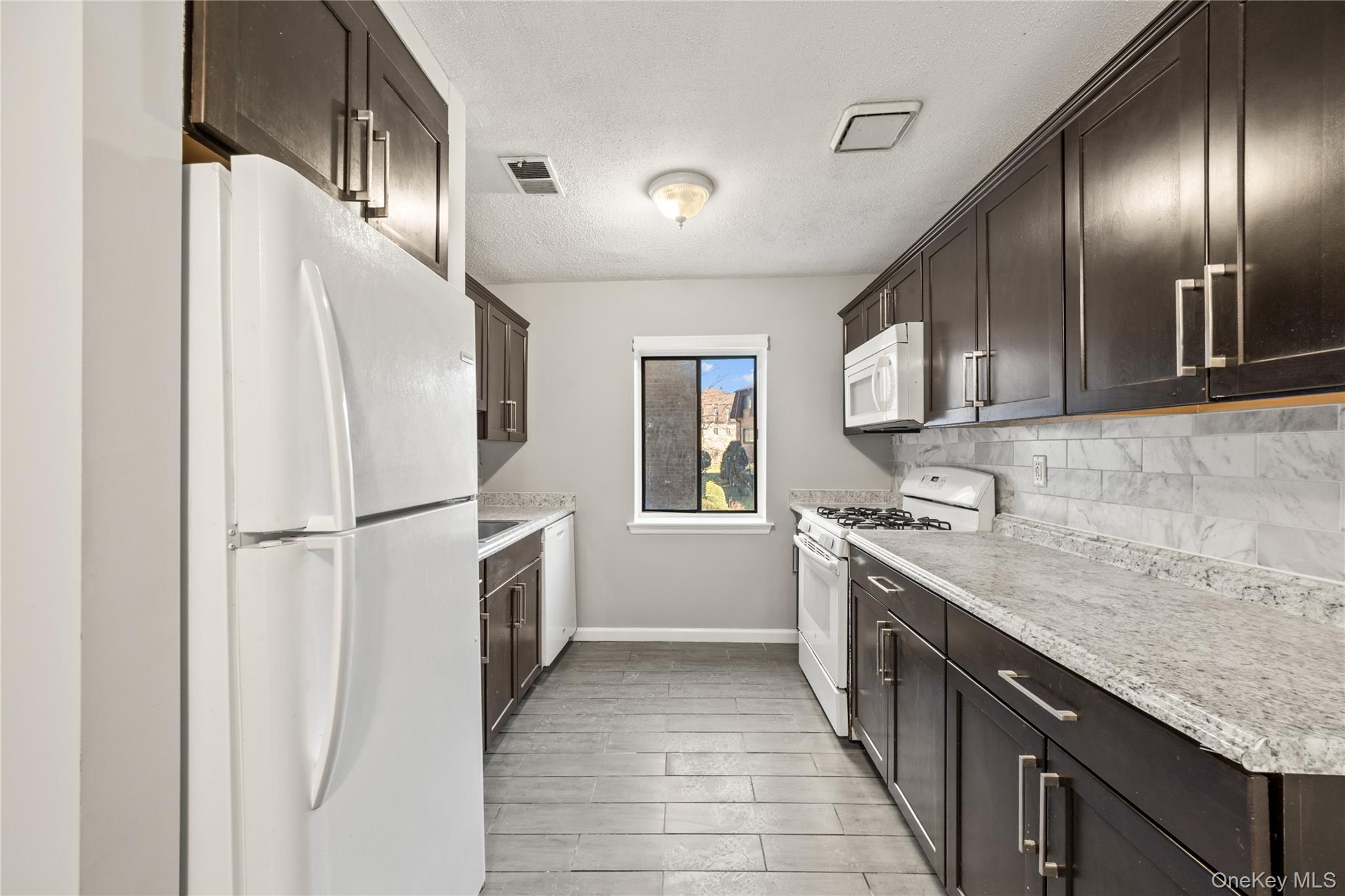 402 Kennedy Drive Spring Valley, NY 10977 - Photo 6 of 26 a kitchen with a refrigerator sink and stove
