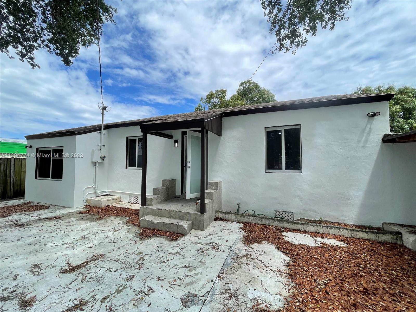 2607 Northwest 29th Street Miami, FL 33142 - Photo 1 of 13 a backyard of a house