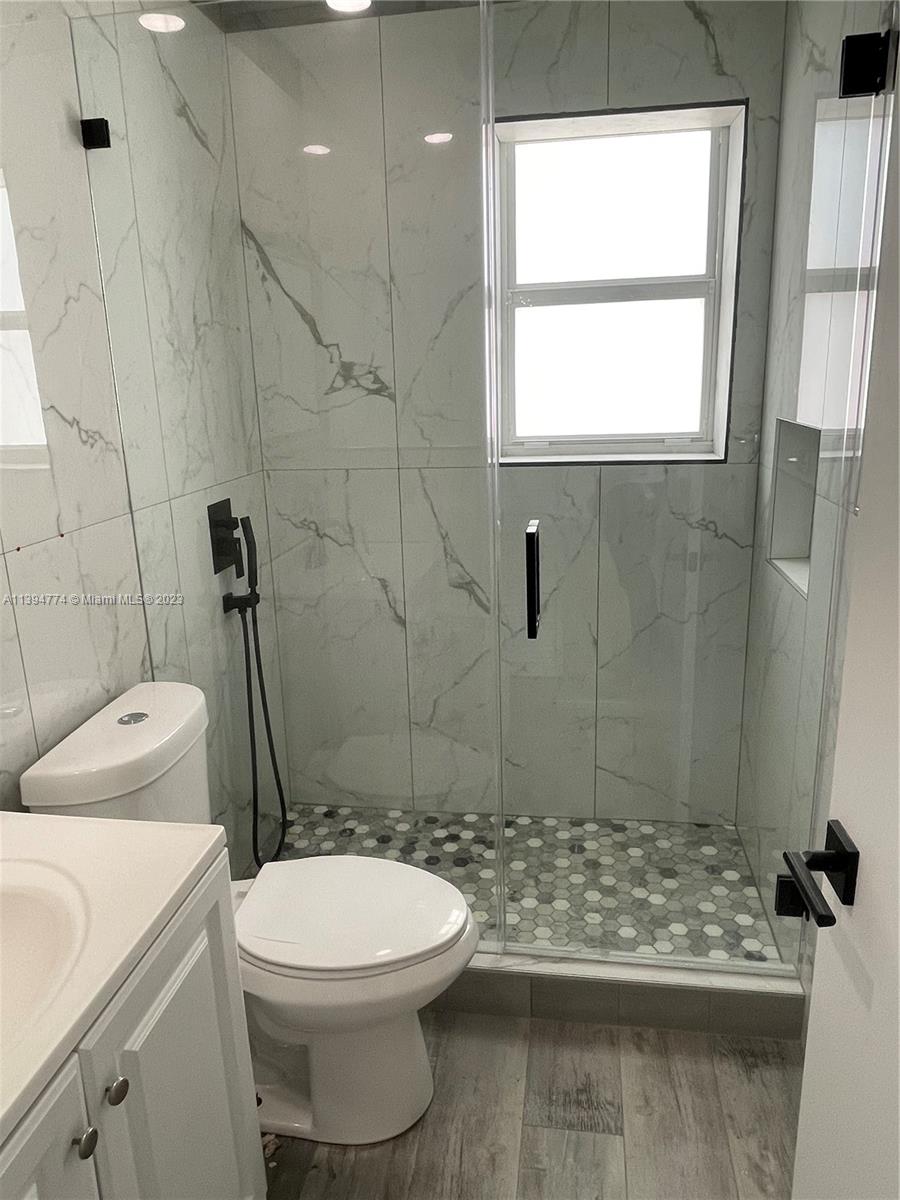 2607 Northwest 29th Street Miami, FL 33142 - Photo 13 of 13 a bathroom with a sink a toilet and shower