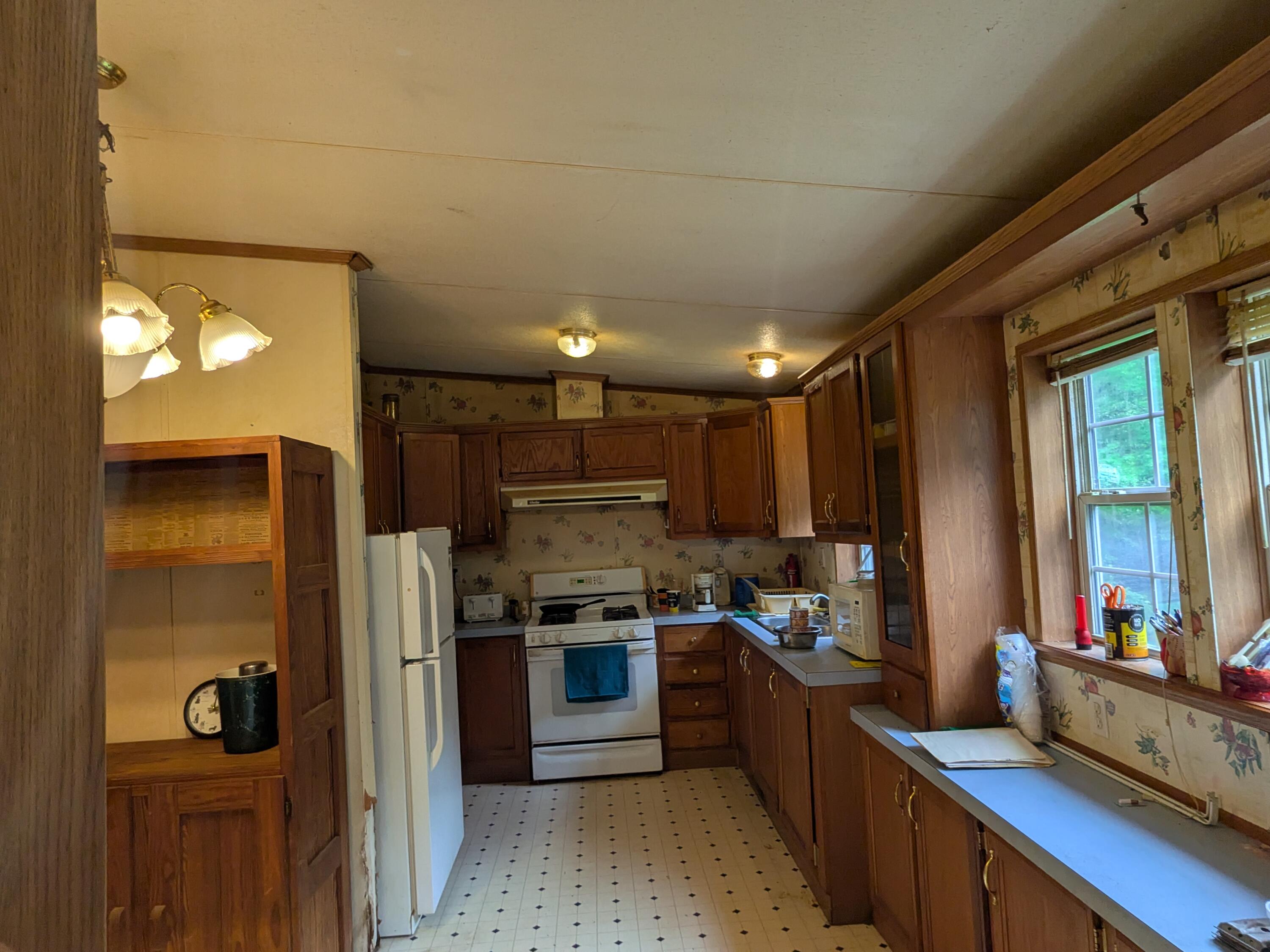 135 Weber Lane Gilbert, PA 18331 - Photo 3 of 9 a kitchen with stainless steel appliances kitchen island granite countertop a refrigerator and a sink