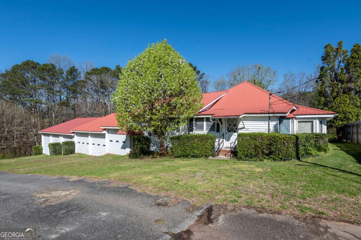 1695 Old Canton Road Ball Ground, GA 30107 - Photo 3 of 43 a view of a house with a yard