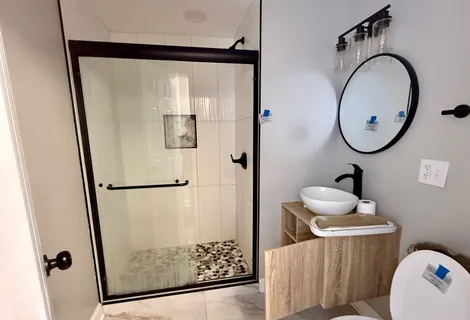 a bathroom with a sink toilet and a mirror