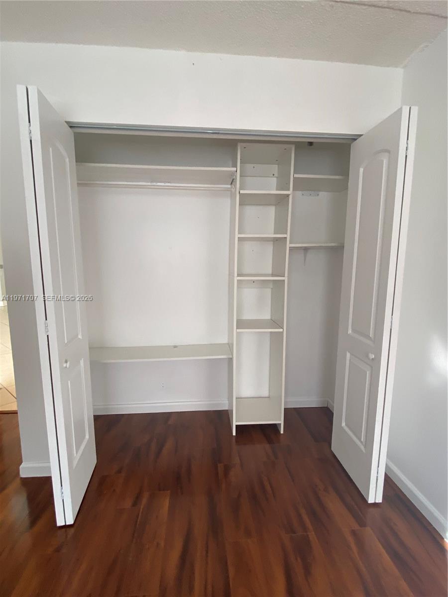 6155 Northwest 186th Street, Unit 308 Hialeah, FL 33015 - Photo 13 of 34 a view of walk in closet with empty racks