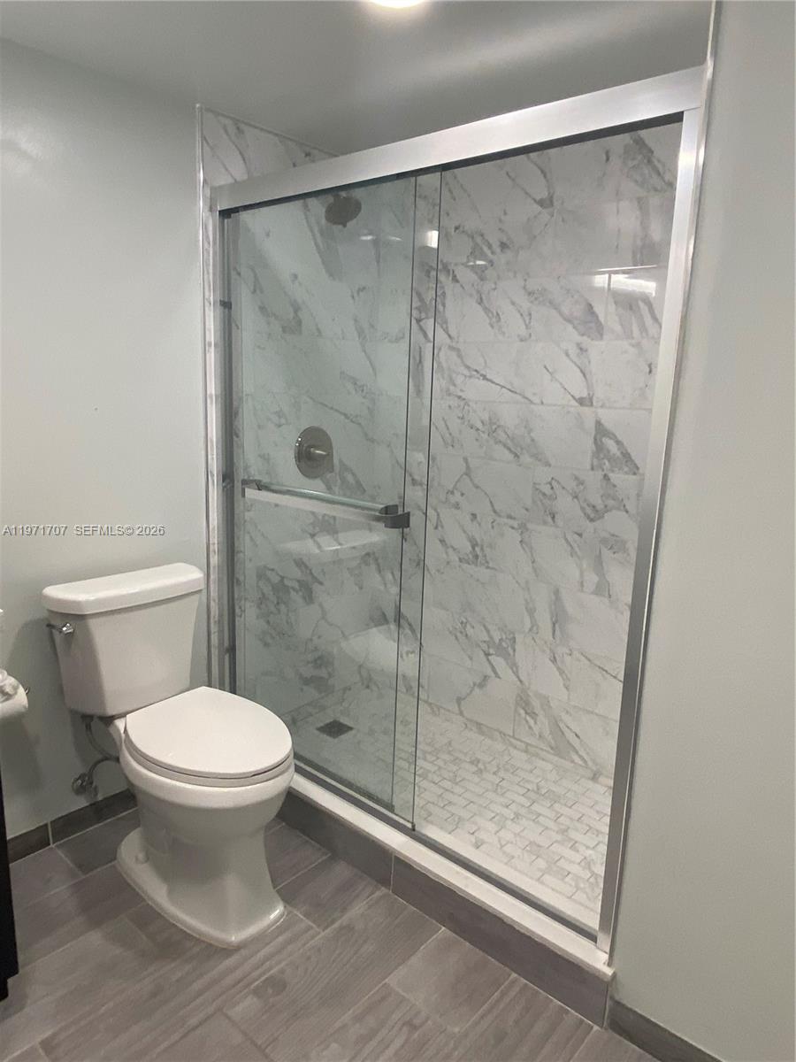 6155 Northwest 186th Street, Unit 308 Hialeah, FL 33015 - Photo 15 of 34 a bathroom with a shower and a toilet
