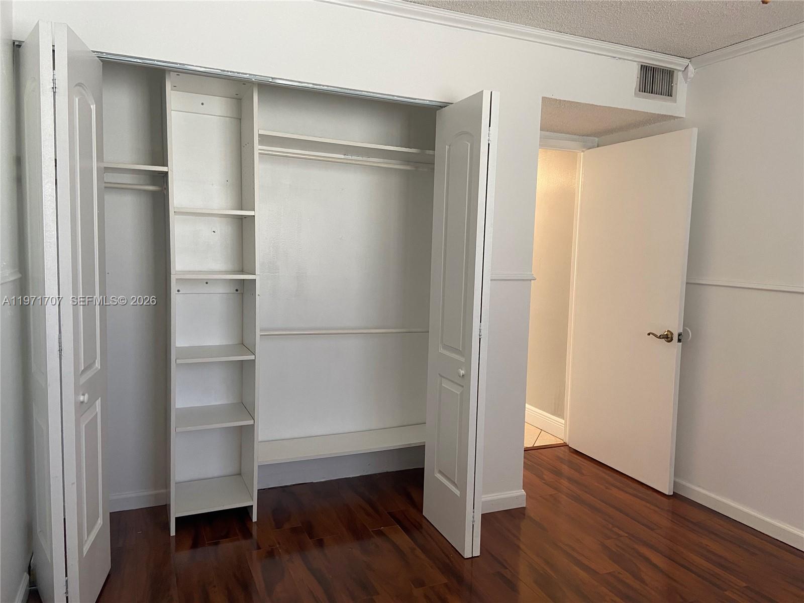 6155 Northwest 186th Street, Unit 308 Hialeah, FL 33015 - Photo 18 of 34 a room with wooden floor