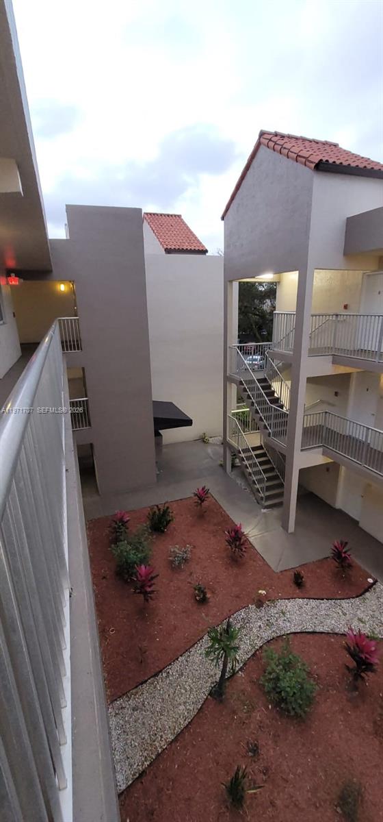 6155 Northwest 186th Street, Unit 308 Hialeah, FL 33015 - Photo 24 of 34 a front view of a house with a yard