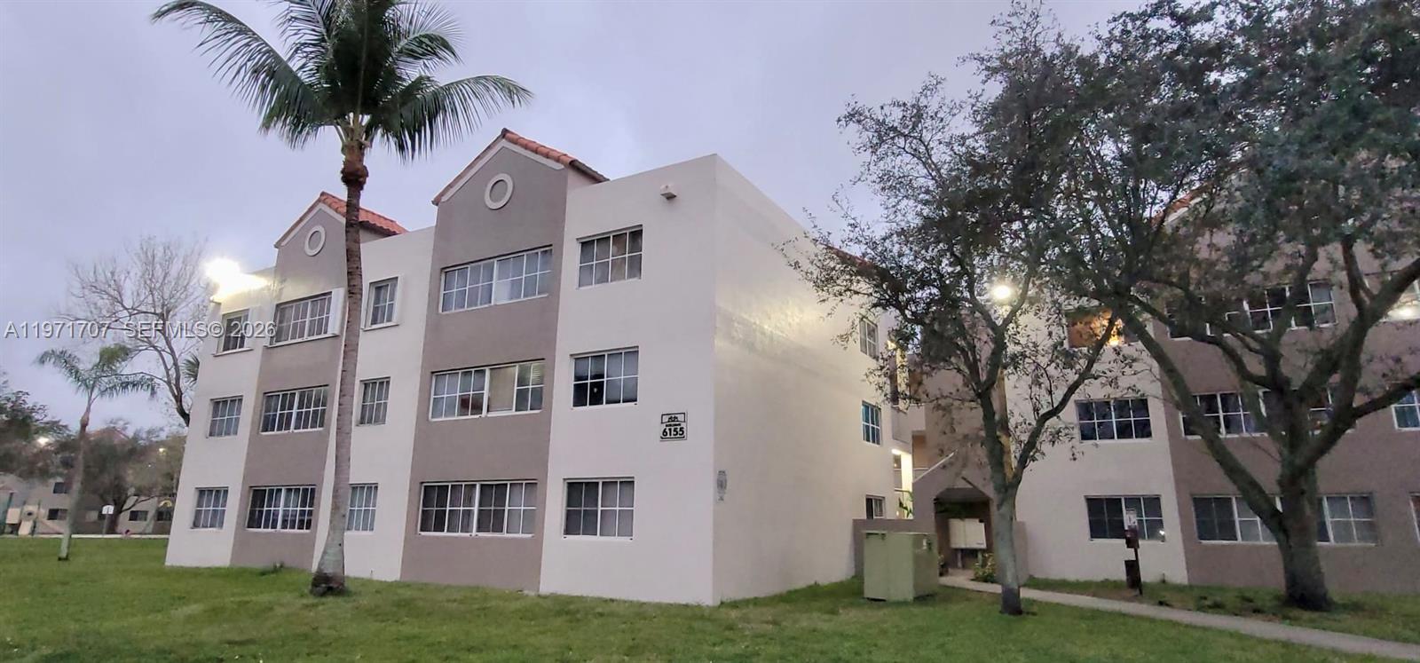 6155 Northwest 186th Street, Unit 308 Hialeah, FL 33015 - Photo 30 of 34 a view of house with yard