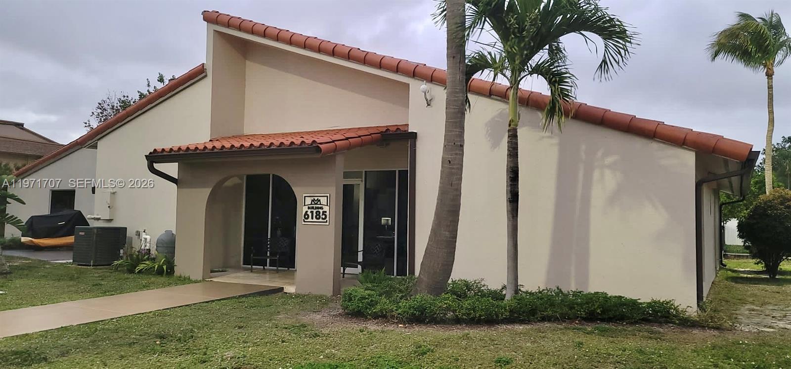 6155 Northwest 186th Street, Unit 308 Hialeah, FL 33015 - Photo 32 of 34 a view of a house with a yard and plants