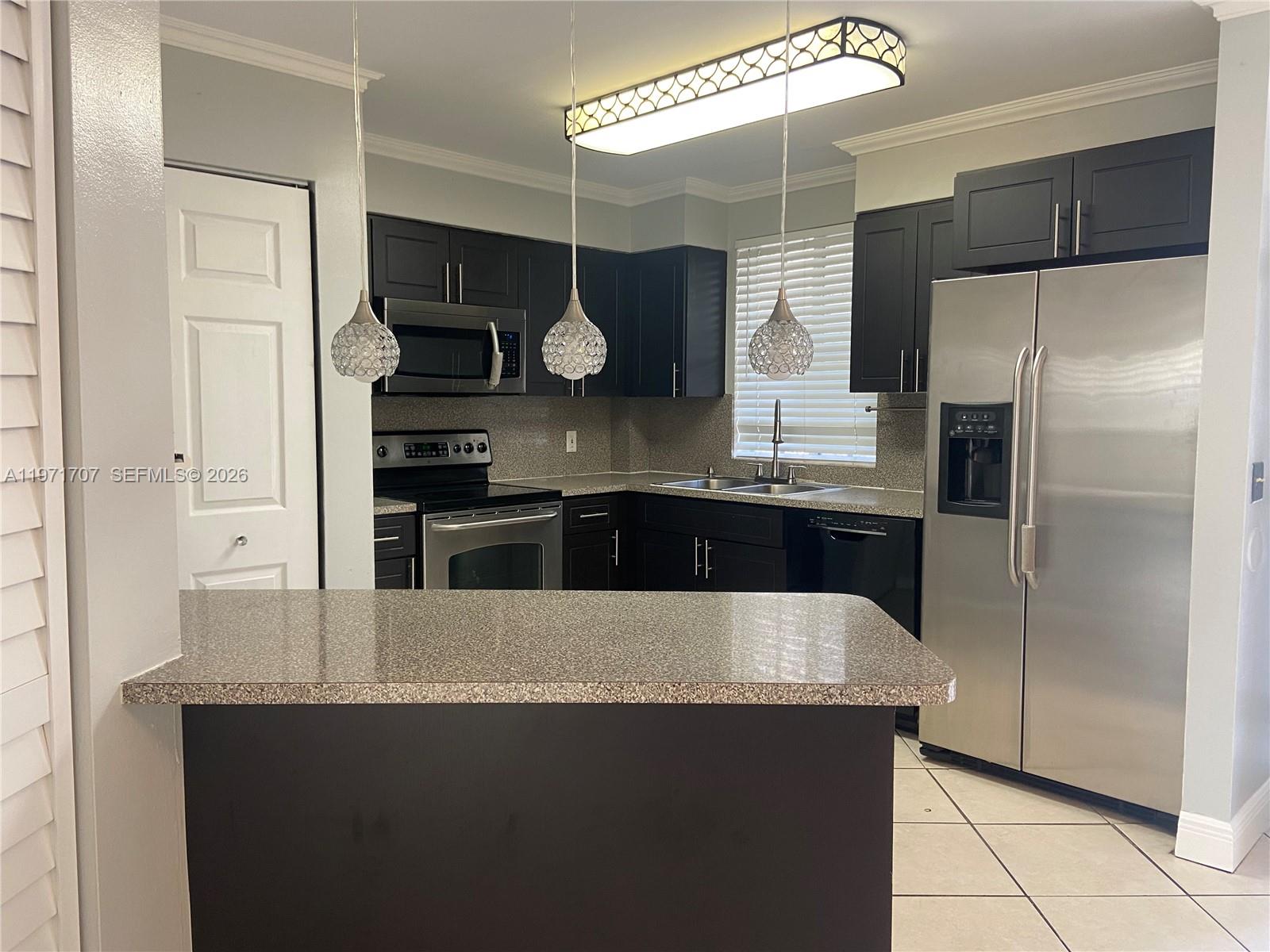 6155 Northwest 186th Street, Unit 308 Hialeah, FL 33015 - Photo 6 of 34 a kitchen with stainless steel appliances a refrigerator and a stove