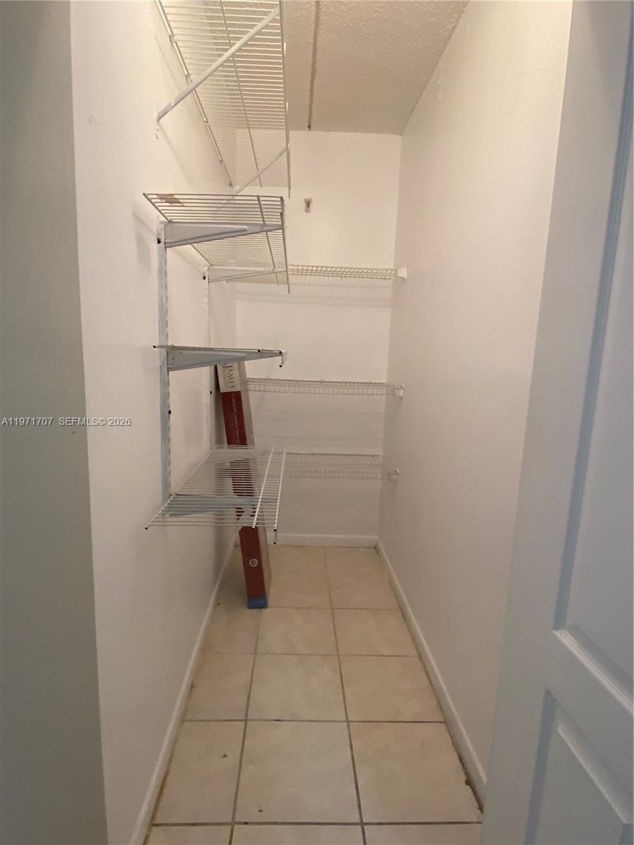 6155 Northwest 186th Street, Unit 308 Hialeah, FL 33015 - Photo 7 of 34 a view of storage and utility room with racks on the wall