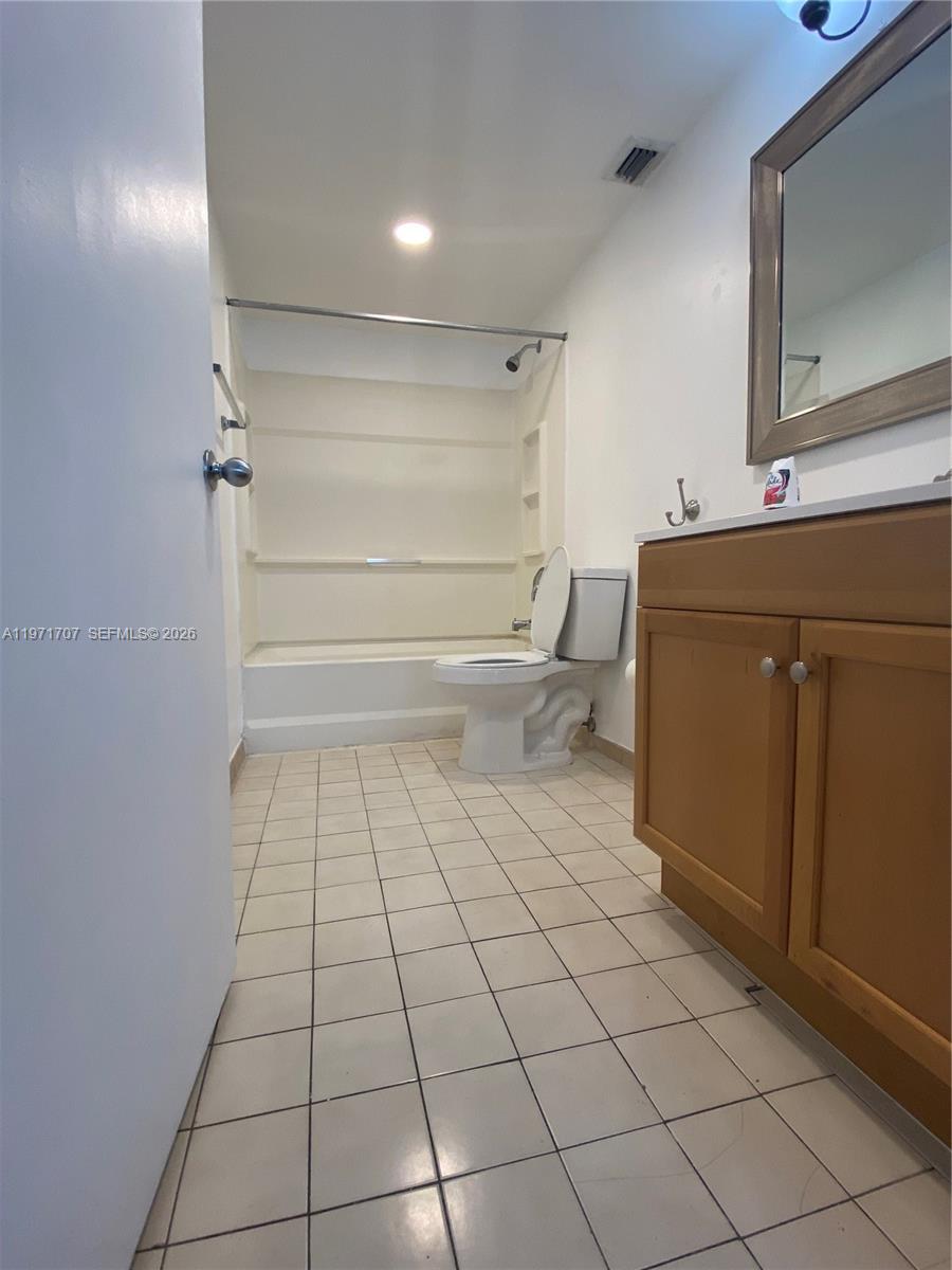 6155 Northwest 186th Street, Unit 308 Hialeah, FL 33015 - Photo 10 of 34 a bathroom with a sink a toilet and a mirror