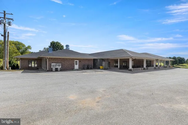 a front view of a house with a yard and a garage