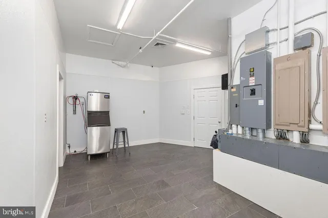 a view of a hallway with wooden floor and closet
