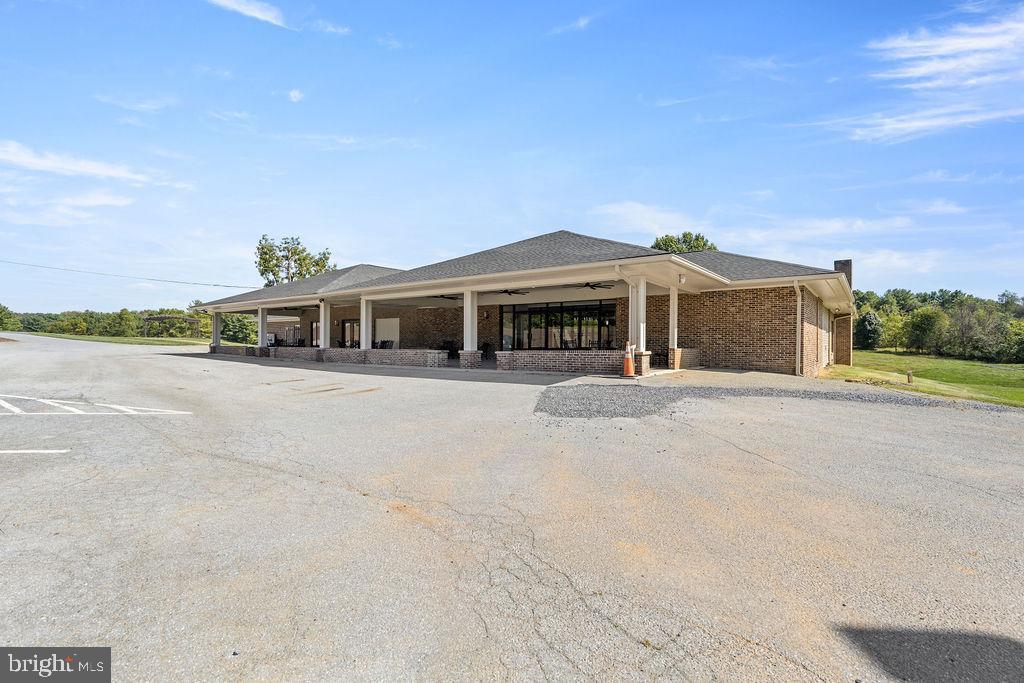 838 Bowling Green Road Front Royal, VA 22630 - Photo 3 of 66 a front view of a house with a yard and palm trees