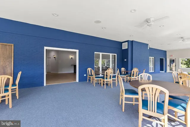 a view of an entryway with floor to ceiling windows and a chandelier