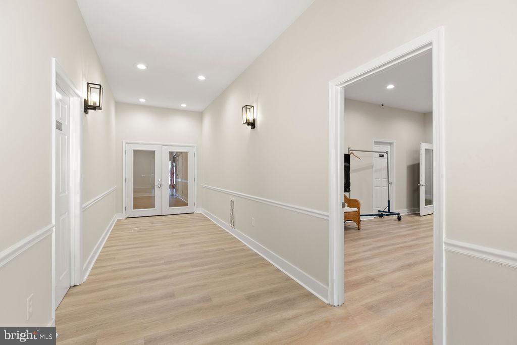 838 Bowling Green Road Front Royal, VA 22630 - Photo 43 of 66 a view of a hallway with wooden floor and a living room