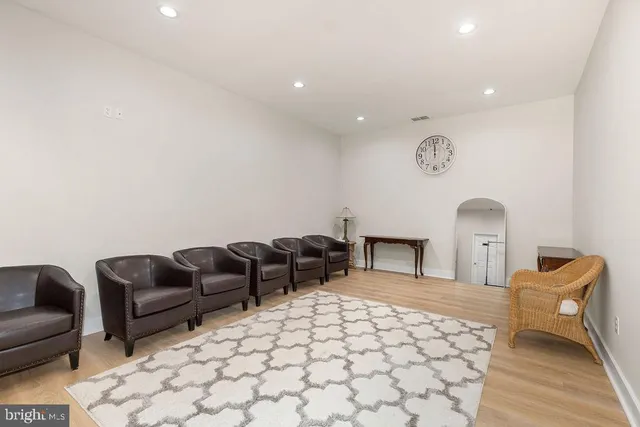 a view of a living room and kitchen with furniture wooden floor and a window