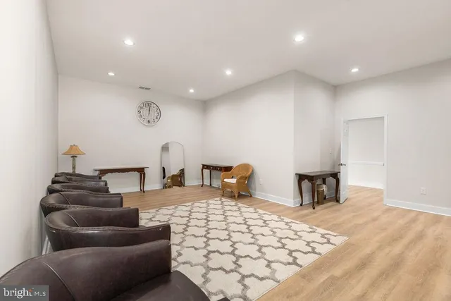 a living room with furniture and large windows