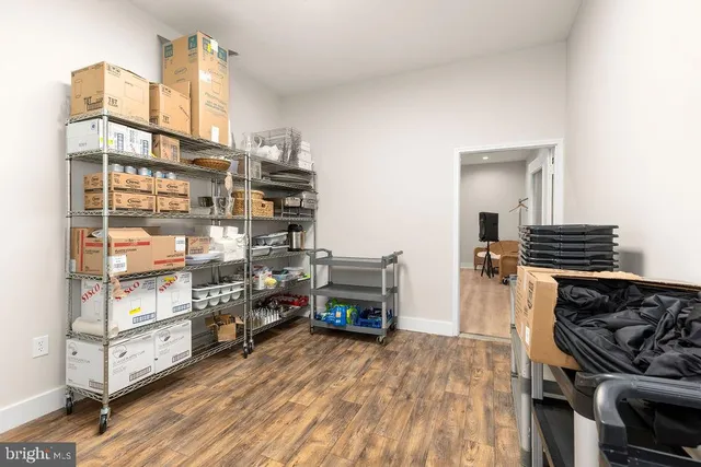 a living room with furniture a table and kitchen view