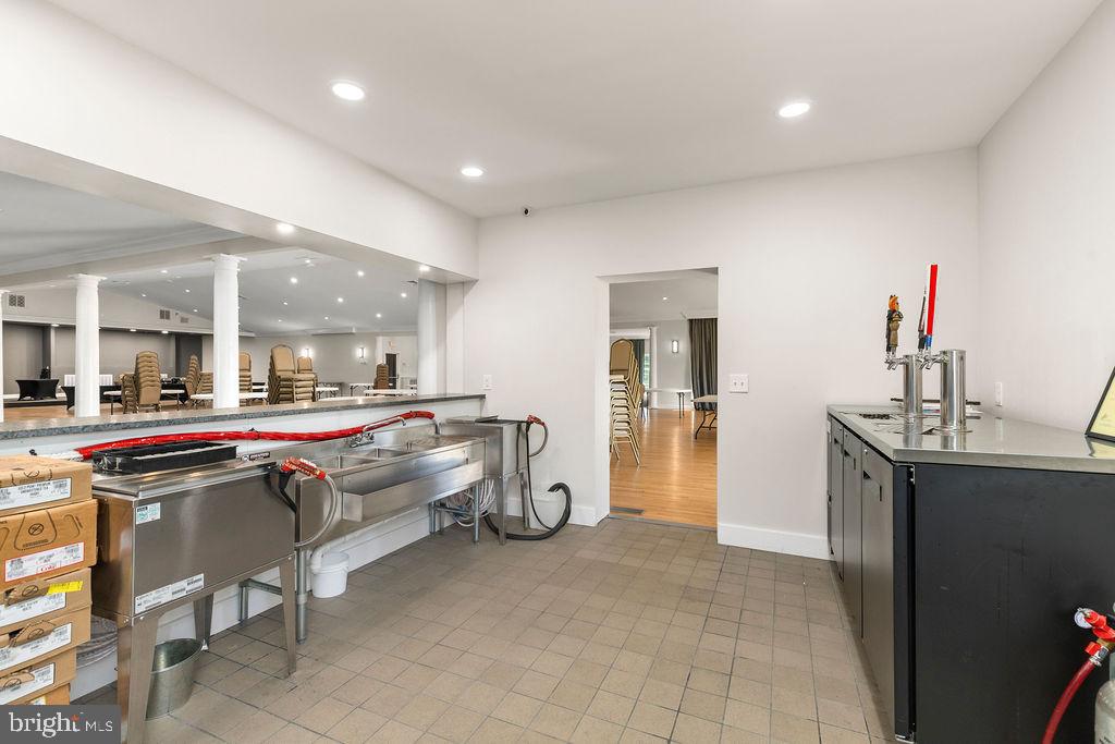838 Bowling Green Road Front Royal, VA 22630 - Photo 54 of 66 a living room with stainless steel appliances furniture a rug and a kitchen view