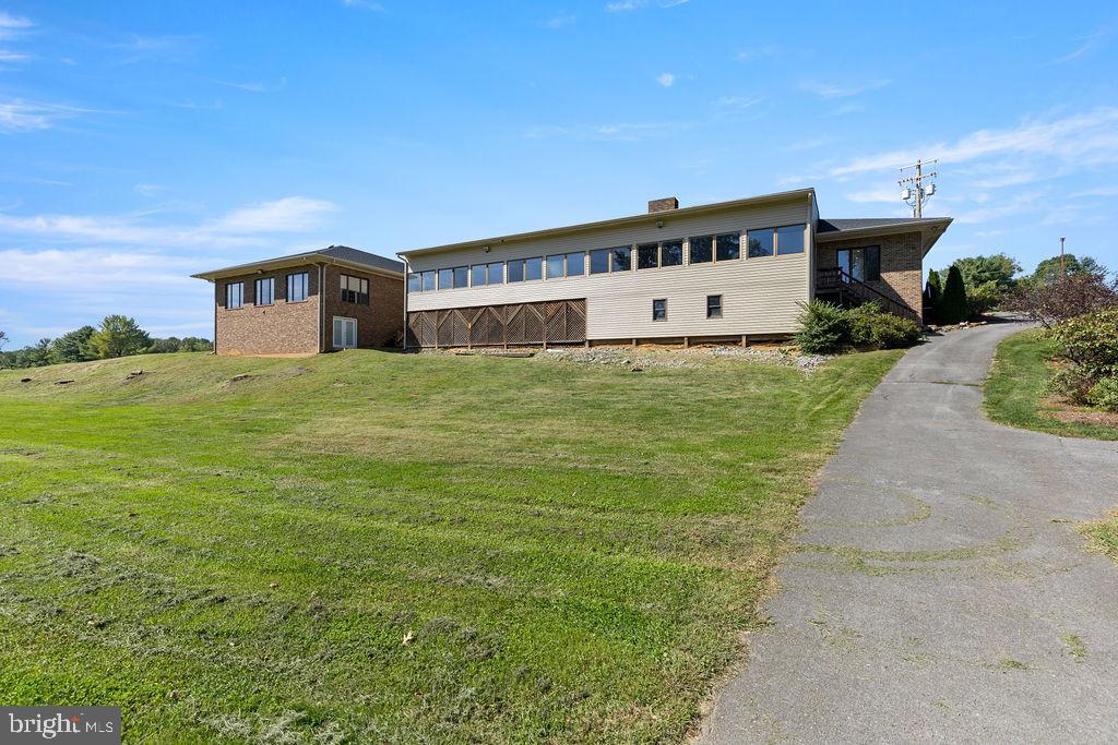 838 Bowling Green Road Front Royal, VA 22630 - Photo 63 of 66 a large house with a big yard and large trees