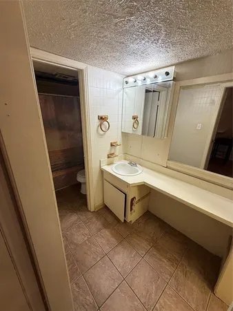 a kitchen with a sink cabinets and a stove top oven