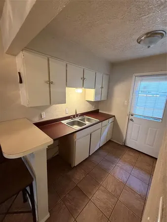 a kitchen with stainless steel appliances a refrigerator and a stove top oven