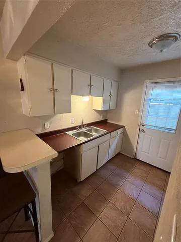 a kitchen with stainless steel appliances a refrigerator and a stove top oven